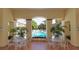 Covered patio with tile flooring offers seating and views of the community pool at 3623 Square West Ln # 5, Sarasota, FL 34238