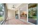 Covered patio featuring tiled floor, a ceiling fan, and an open view to the kitchen at 3623 Square West Ln # 5, Sarasota, FL 34238