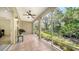 Relaxing screened patio featuring tile flooring, a ceiling fan, and lush outdoor views at 3623 Square West Ln # 5, Sarasota, FL 34238