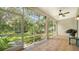 Screened patio featuring tiled floor, a ceiling fan, and a view to a lush garden at 3623 Square West Ln # 5, Sarasota, FL 34238