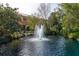 Scenic pond with a fountain surrounded by lush landscaping and a view of the home at 3623 Square West Ln # 5, Sarasota, FL 34238