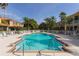 Inviting community pool surrounded by palm trees, lounge chairs, and well-maintained landscaping at 3623 Square West Ln # 5, Sarasota, FL 34238