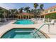 Community pool area features pool, spa and covered lounge, with sun loungers at 3623 Square West Ln # 5, Sarasota, FL 34238