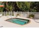 Outdoor spa with tile surround, set in landscaped area with white fencing at 3623 Square West Ln # 5, Sarasota, FL 34238