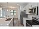 Contemporary kitchen with marble countertops, stainless steel appliances, and stylish fixtures at 3812 Wenona Dr, North Port, FL 34288