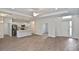 Bright, open-concept living space with wood flooring and modern kitchen at 3812 Wenona Dr, North Port, FL 34288