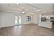 Open-concept living area with wood floors, tray ceiling, and modern kitchen at 3812 Wenona Dr, North Port, FL 34288