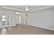 Bright living room with wood flooring, tray ceilings, and double glass doors at 3812 Wenona Dr, North Port, FL 34288