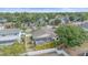 An aerial view shows a home with a screened pool surrounded by palm trees and a white fence and green trees at 4053 Lancaster Dr, Sarasota, FL 34241