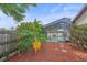 Landscaped backyard with a screen-enclosed pool and patio area, offering privacy and relaxation at 4053 Lancaster Dr, Sarasota, FL 34241