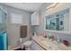 The bathroom is equipped with a shower and a vanity sink offering practical functionality and timeless style at 4053 Lancaster Dr, Sarasota, FL 34241