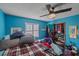 This bedroom features ample natural light, closet, and a vibrant blue accent wall for a modern and inviting feel at 4053 Lancaster Dr, Sarasota, FL 34241