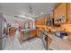 This kitchen features stainless steel appliances, wood cabinets, an island, and an open layout to the dining area at 4053 Lancaster Dr, Sarasota, FL 34241