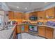 This kitchen boasts wood cabinets, stainless steel appliances, granite countertops, and tile floors creating a functional workspace at 4053 Lancaster Dr, Sarasota, FL 34241