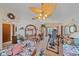 Spacious living room with tiled floors, ceiling fan, display shelving, and ample natural light, ideal for entertaining at 4053 Lancaster Dr, Sarasota, FL 34241