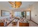Bright living room with tiled floors, ceiling fan, large windows, and comfortable seating, creating a welcoming space at 4053 Lancaster Dr, Sarasota, FL 34241