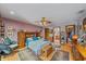 Spacious main bedroom featuring a ceiling fan, wood floors, and an ensuite bathroom and walk-in closet at 4053 Lancaster Dr, Sarasota, FL 34241