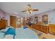 This is the main bedroom featuring generous closet space, wood floors, ceiling fan and an ensuite bathroom at 4053 Lancaster Dr, Sarasota, FL 34241