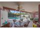 Enclosed patio with ceiling fan and wicker furniture set, providing a shaded pool view at 4053 Lancaster Dr, Sarasota, FL 34241