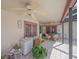 Covered patio area with wicker furniture, ceiling fans, and access to the landscaped backyard at 4053 Lancaster Dr, Sarasota, FL 34241