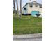Charming two-story home featuring a blue garage door and light-colored siding, complemented by a well-maintained front lawn at 4066 Amberjack Dr, Hernando Beach, FL 34607