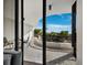 A covered outdoor balcony has ample space for dining, relaxing, and enjoying scenic views through large sliding doors at 415 L Ambiance Dr # D306, Longboat Key, FL 34228