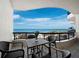 A beachfront balcony features a table with seating overlooking the ocean at 415 L Ambiance Dr # D306, Longboat Key, FL 34228
