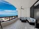 Relaxing balcony area overlooking ocean views, a seating area with a ceiling fan for a comfortable outdoor retreat at 415 L Ambiance Dr # D306, Longboat Key, FL 34228