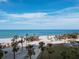 Picturesque beach view with clear blue waters and swaying palm trees in the background at 415 L Ambiance Dr # D306, Longboat Key, FL 34228