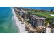 Aerial view of beachfront condos along a beautiful coastline, with a golf course nearby at 415 L Ambiance Dr # D306, Longboat Key, FL 34228