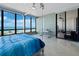 This bedroom features oversized windows offering great views and clear acrylic furniture at 415 L Ambiance Dr # D306, Longboat Key, FL 34228
