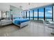This bedroom features oversized windows offering great views and clear acrylic furniture at 415 L Ambiance Dr # D306, Longboat Key, FL 34228