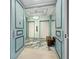 Elegant elevator lobby featuring blue trim, marble floors, decorative lighting and seating at 415 L Ambiance Dr # D306, Longboat Key, FL 34228