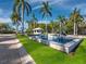 Elegant entrance with a fountain, lush landscaping, and a view of the condo community at 415 L Ambiance Dr # D306, Longboat Key, FL 34228