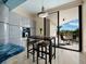 Bright eat-in kitchen area with modern cabinets, a breakfast table, and access to outdoor patio at 415 L Ambiance Dr # D306, Longboat Key, FL 34228