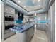 Modern kitchen with stone island, gray cabinets, stainless appliances and views of the living areas at 415 L Ambiance Dr # D306, Longboat Key, FL 34228