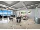 Bright living room with floor to ceiling windows, sleek furniture and designer touches with beautiful ocean view at 415 L Ambiance Dr # D306, Longboat Key, FL 34228