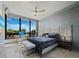 Bright bedroom featuring large windows with great views, modern ceiling fan, and work space by the window at 415 L Ambiance Dr # D306, Longboat Key, FL 34228