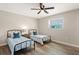Bright bedroom features hardwood floors, ceiling fan, and two twin beds with matching linens at 420 63Rd St # B East, Holmes Beach, FL 34217