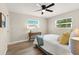 Cozy bedroom with natural light, ceiling fan, and wood-look flooring offers a relaxing retreat at 420 63Rd St # B East, Holmes Beach, FL 34217