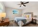 Comfortable bedroom featuring a ceiling fan, wood-look floors, and soft natural light at 420 63Rd St # B East, Holmes Beach, FL 34217