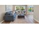 Comfortable living room with a cozy sofa, patterned chairs, and large windows for natural light at 420 63Rd St # B East, Holmes Beach, FL 34217