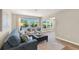 Well-lit living room features a comfortable sofa, patterned chairs, and scenic backyard views at 420 63Rd St # B East, Holmes Beach, FL 34217