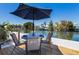 Outdoor patio featuring seating under an umbrella with waterfront views at 420 63Rd St # B East, Holmes Beach, FL 34217