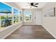 Bright Sun Room features walls of windows, views of the water, and a ceiling fan at 420 63Rd St # B East, Holmes Beach, FL 34217