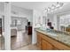 Well-lit bathroom with a view into the bedroom, granite countertop vanity, mirror and a glass-enclosed shower at 4315 45Th W Ave # 103, Bradenton, FL 34210