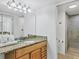 Well-lit bathroom with a granite countertop vanity, mirror, and a glass-enclosed shower for a spa-like experience at 4315 45Th W Ave # 103, Bradenton, FL 34210