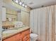 Cozy bathroom featuring granite countertop vanity, a toilet, and a shower-tub combination for convenience at 4315 45Th W Ave # 103, Bradenton, FL 34210