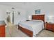 Bright bedroom with a queen bed, tile floors, and a ensuite bathroom featuring a glass enclosed shower at 4315 45Th W Ave # 103, Bradenton, FL 34210
