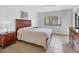 Comfortable bedroom featuring a large bed, wood furniture and ample natural light from the window at 4315 45Th W Ave # 103, Bradenton, FL 34210